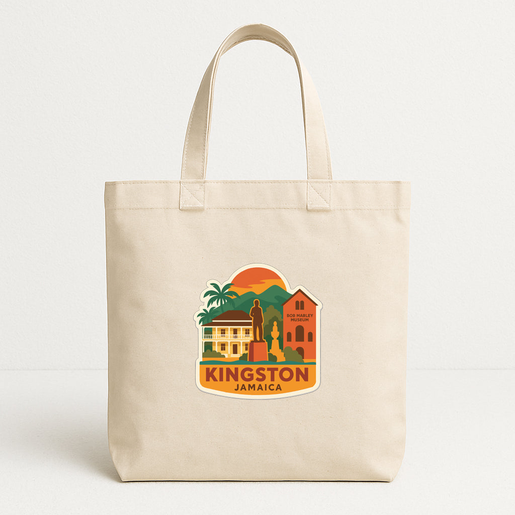A beige tote bag with a printed design depicting landmarks and buildings in Jamaica, including a castle, a church, and a house.