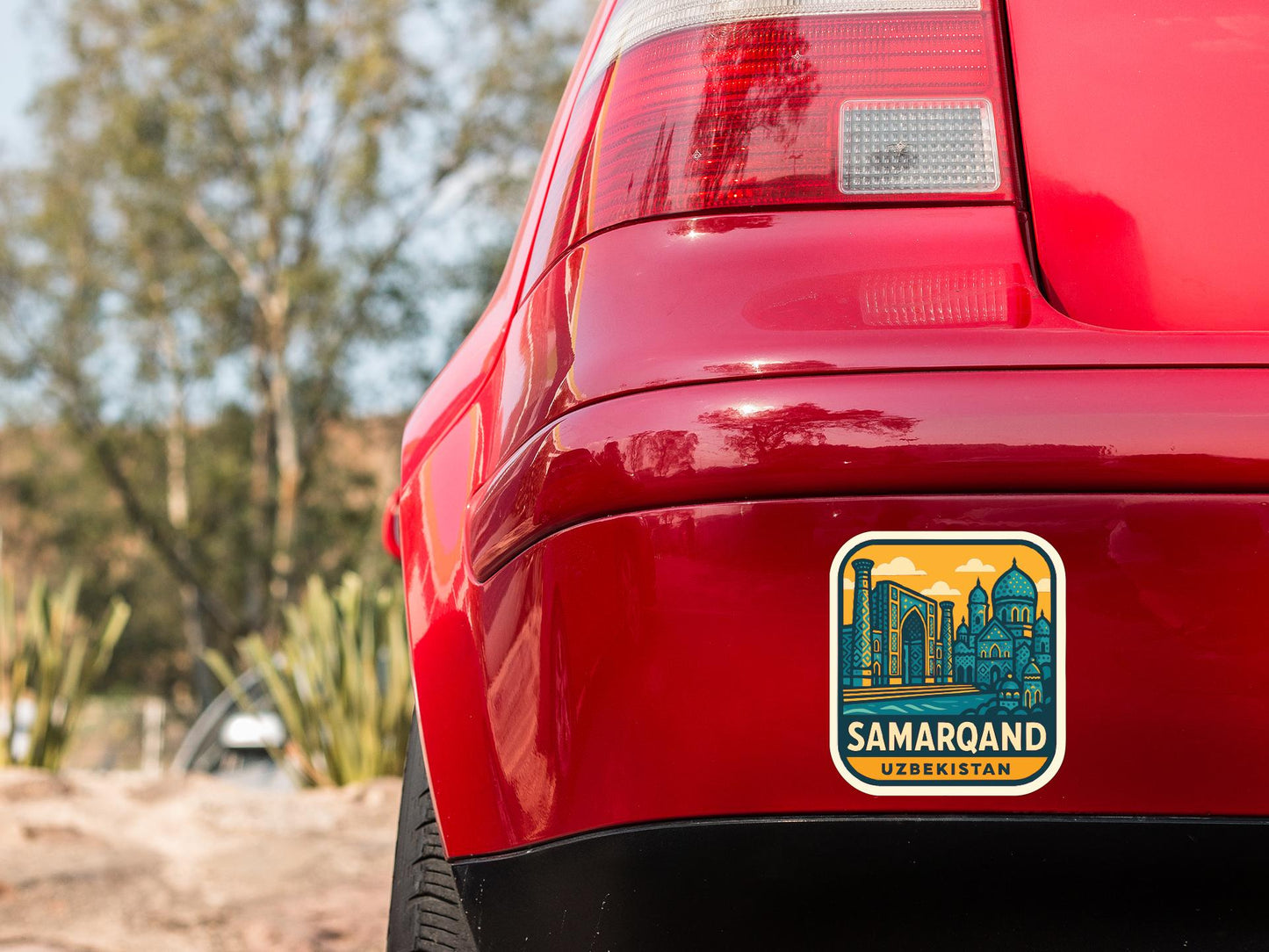 the rear end of a red car with a sticker on the back window that says "SAMARQAND KBRKISTAN".