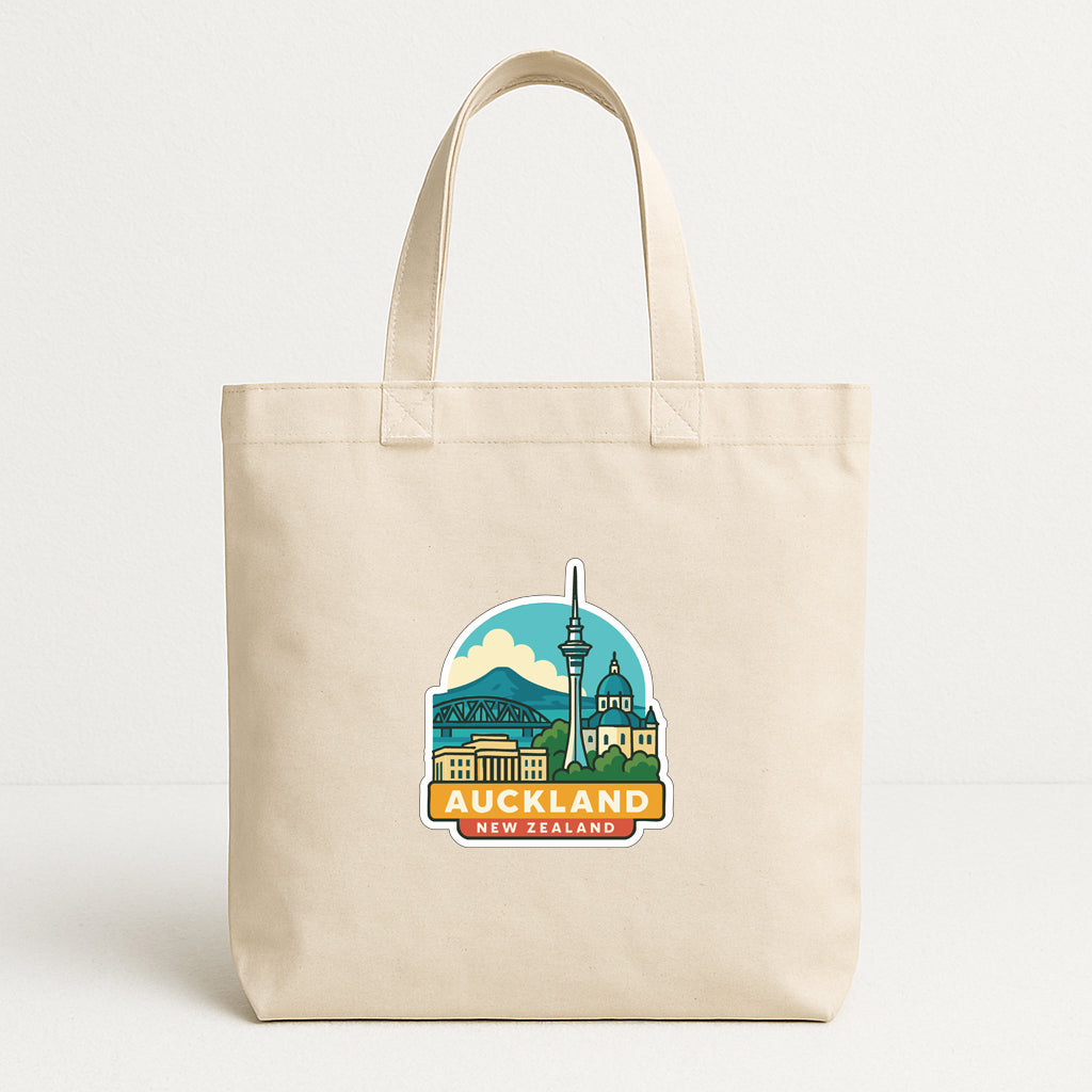 A beige tote bag with a graphic design featuring the city of Auckland, New Zealand.