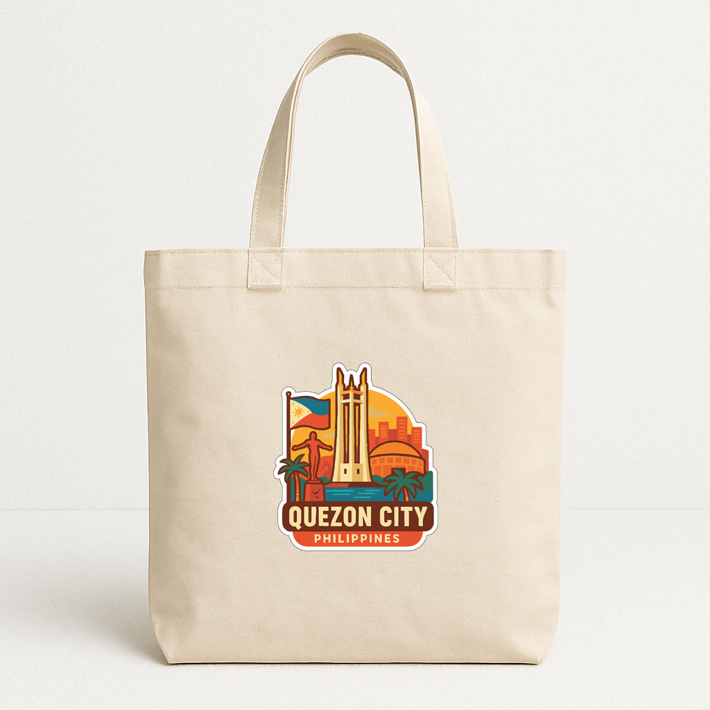 A beige tote bag with a printed design featuring the city of Quezon City, Philippines.