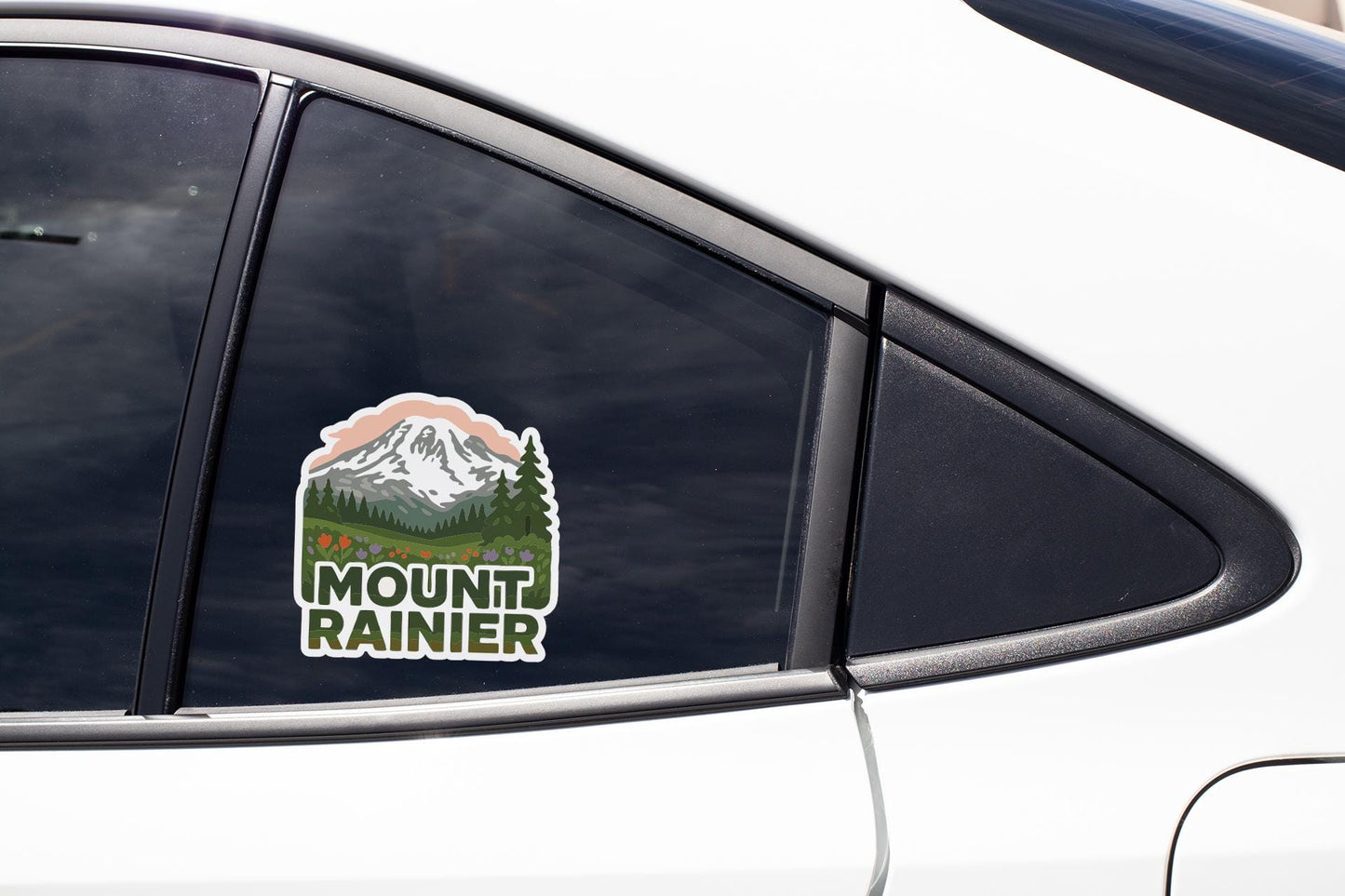 A sticker on the side of a car window that says "Mount Rainier".