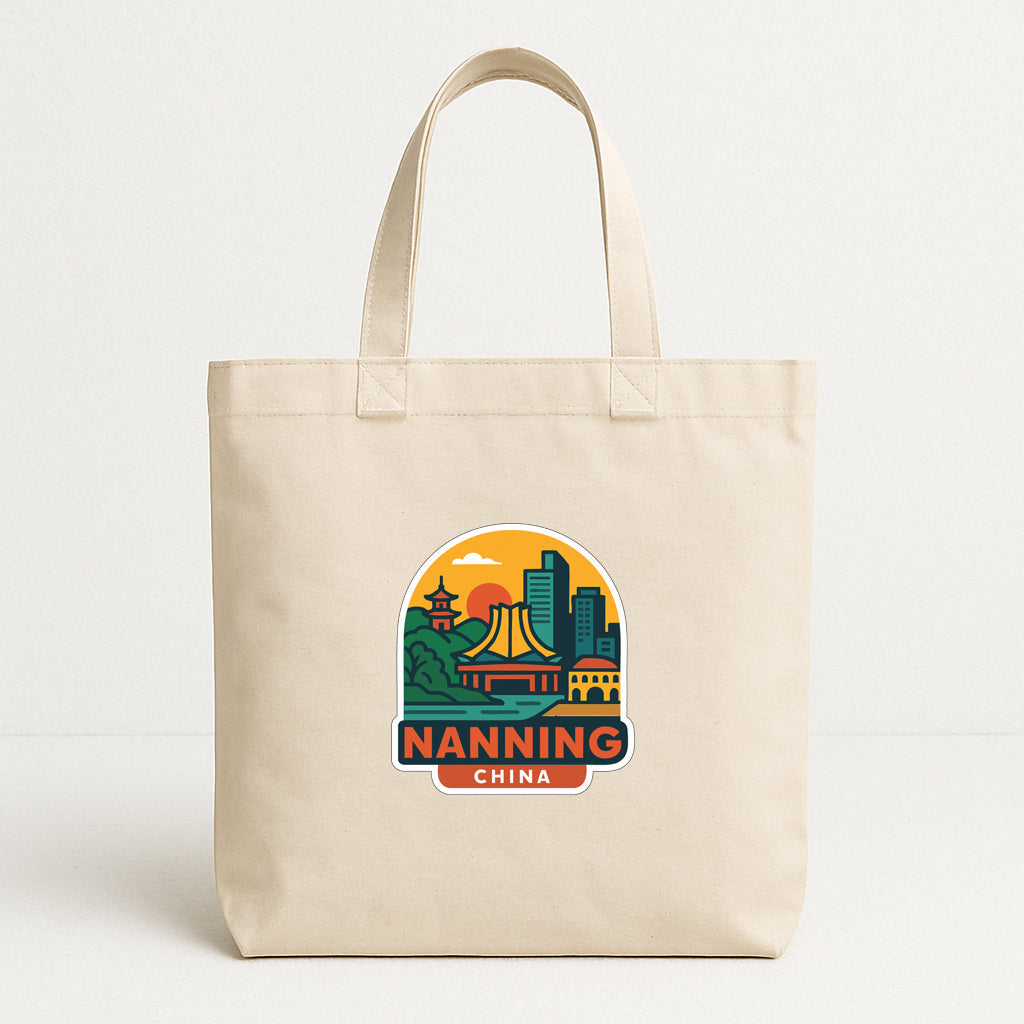 A beige tote bag with a printed design depicting a city skyline and the text "NANNING CHINA" printed on it.