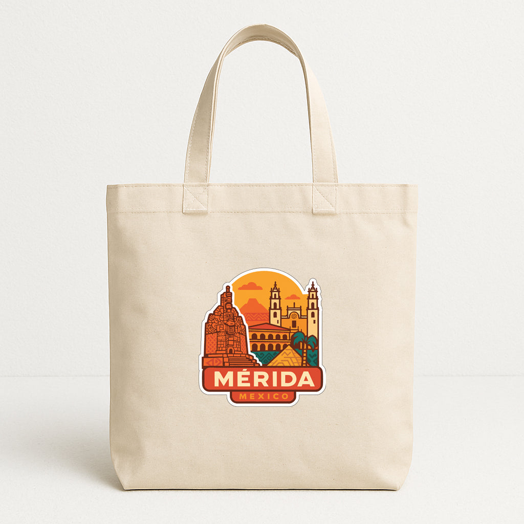 A beige tote bag with a printed design depicting the city of Merida, Mexico.