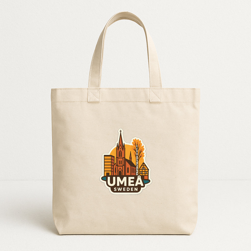 A beige tote bag with a printed design featuring a cityscape and the text "UMEA SWEDEN" printed on it.