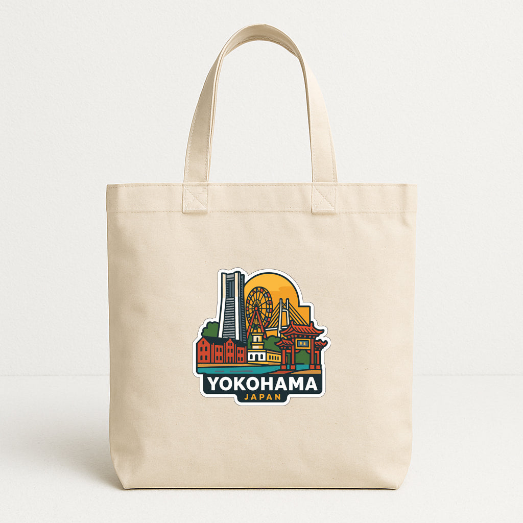 A beige tote bag with a colorful graphic depicting the city of Yokohama, Japan, printed on it.