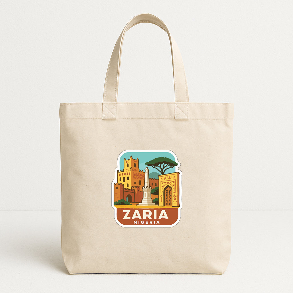 A beige tote bag with a printed design depicting the city of Zaria, Nigeria.