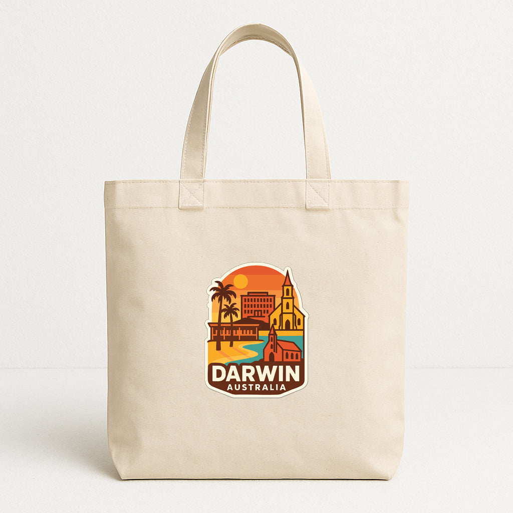 A beige tote bag with a graphic design depicting a cityscape and landmarks, including a church and a palm tree, along with the text "DARWIN AUSTRALIA".