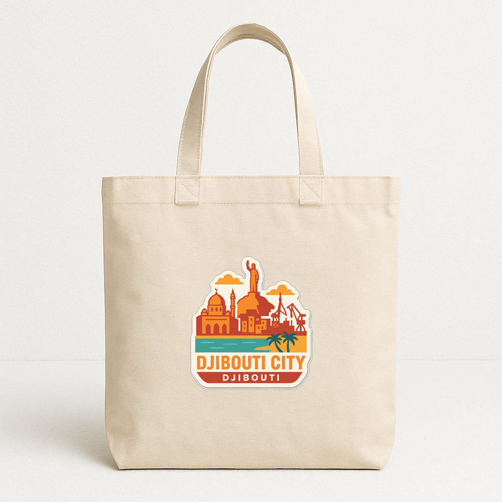 A beige tote bag with a sticker depicting the Djibouti City skyline.