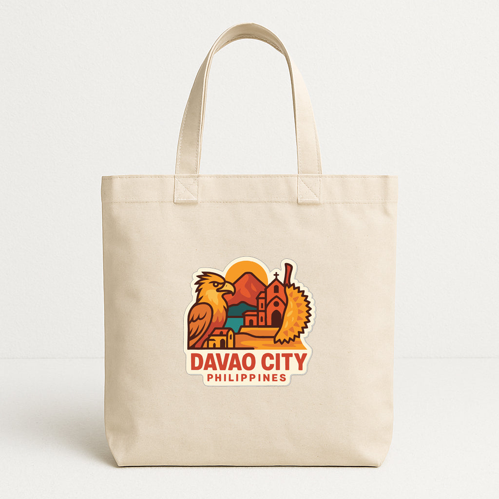 A beige tote bag with a graphic design depicting a cityscape and a bird, along with the text "DAVAO CITY PHILIPPINES".