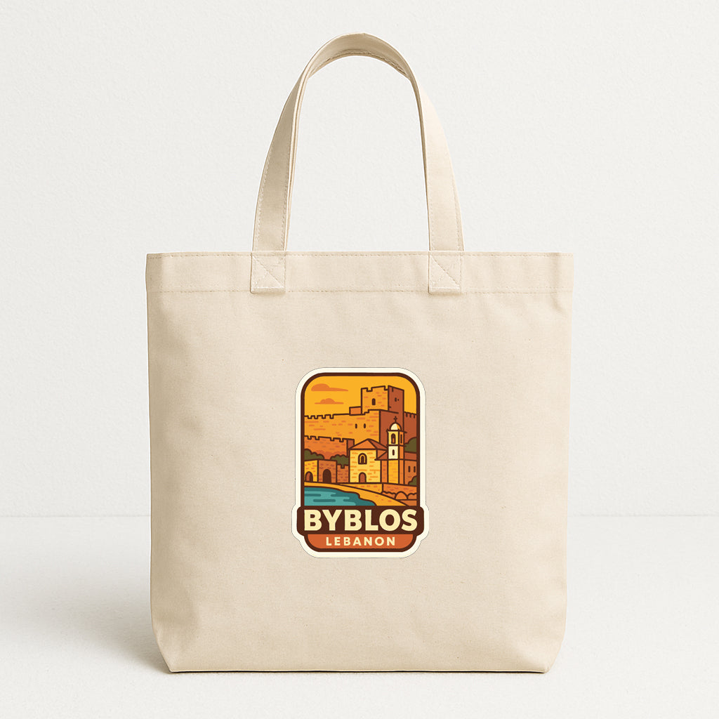 A beige tote bag with a graphic design depicting a cityscape and the text "BYBLOS LEBANON" printed on it.