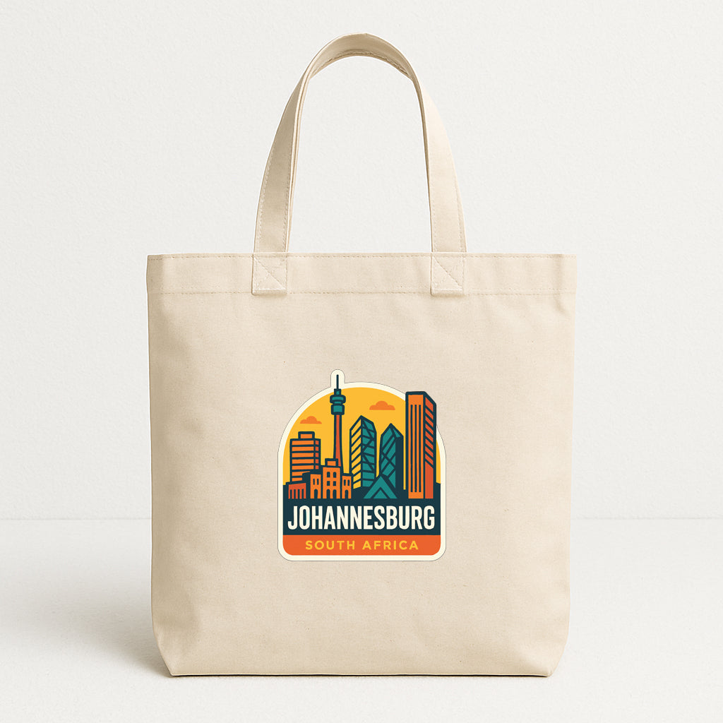 A beige tote bag with a printed design of Johannesburg, South Africa, featuring a city skyline and the text "JOHANNESBURG SOUTH AFRICA".
