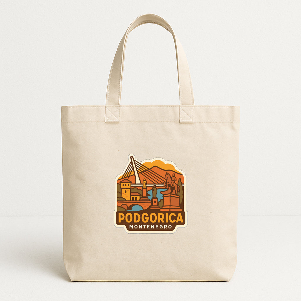 A beige tote bag with a graphic design featuring a bridge and the text "PODGORICA MONTENEGRO".