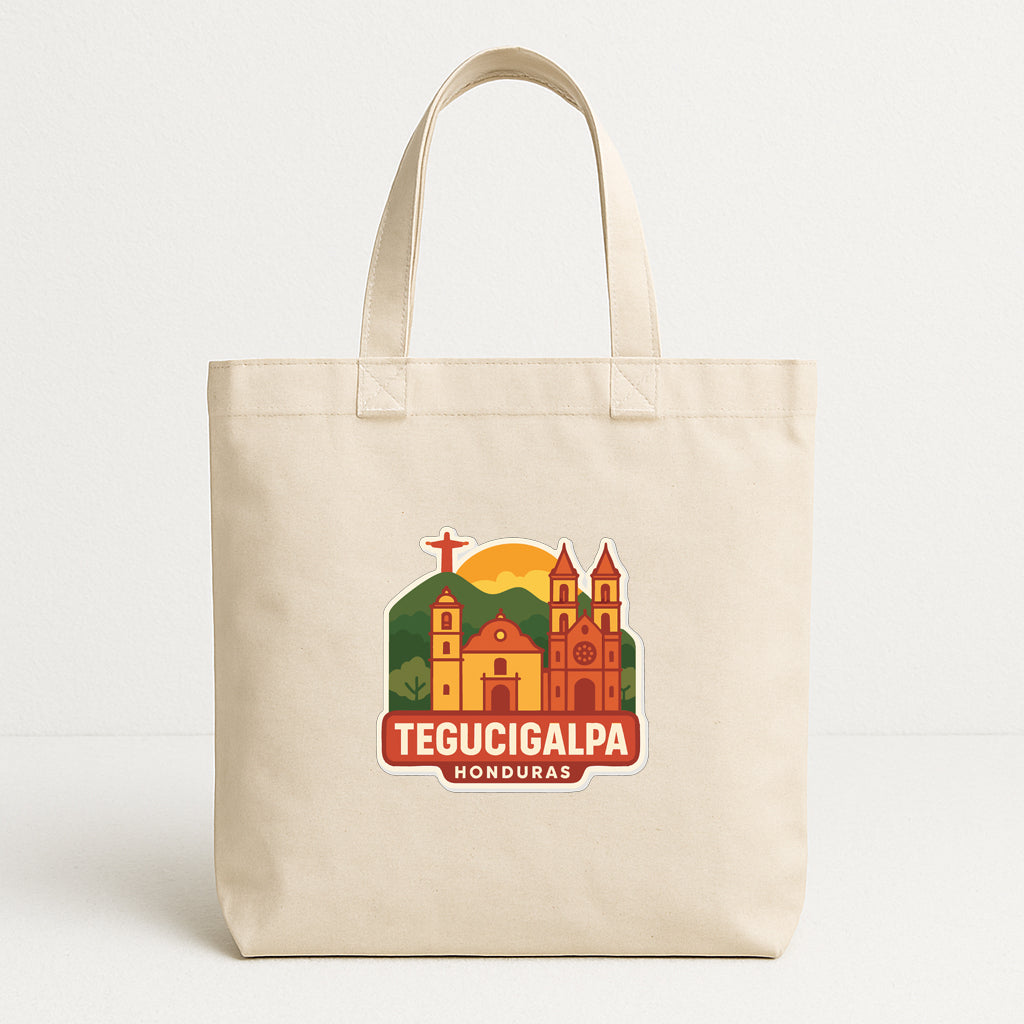 A beige tote bag with a graphic design featuring a church and mountains, along with the text "TEGUCIGALPA HONDURAS".