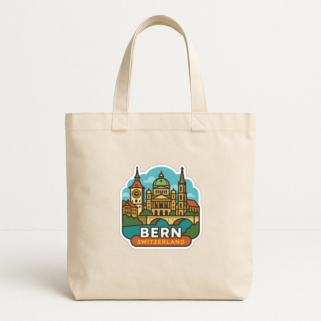 A beige tote bag with a printed design of a city skyline and the text "BERN SWITZERLAND" on it.