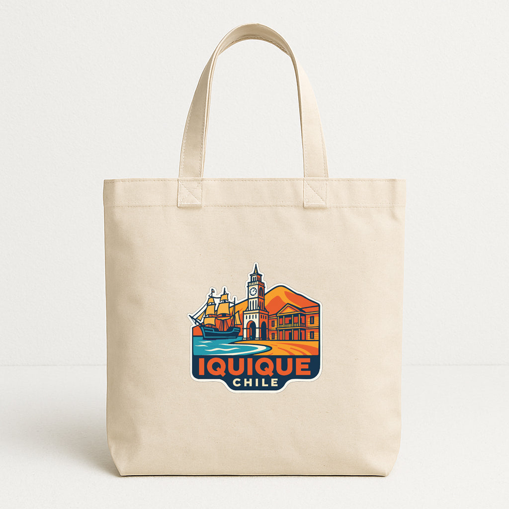 A beige tote bag with a graphic design featuring a cityscape and the text "IQUIQUE CHILE" printed on it.