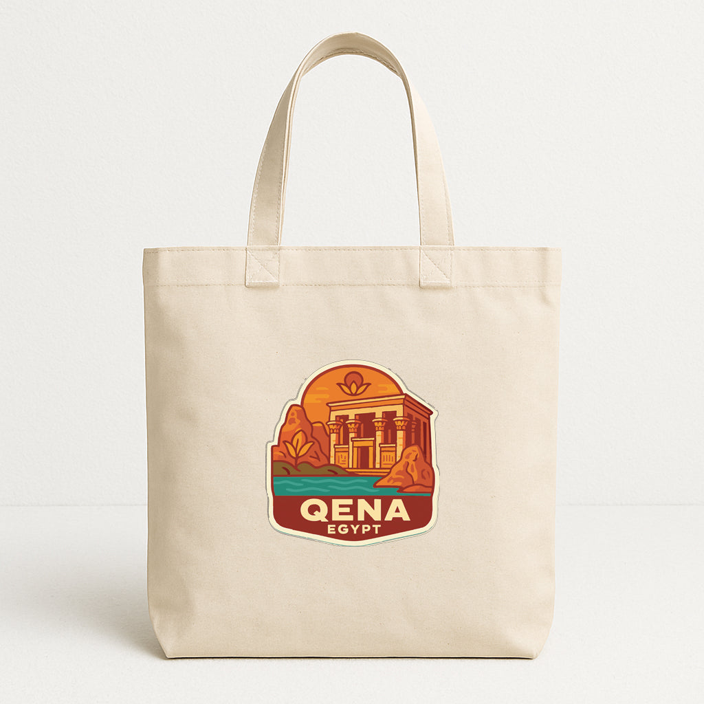 A beige tote bag with a graphic design depicting a temple and a body of water, along with the text "QENA EGYPT".