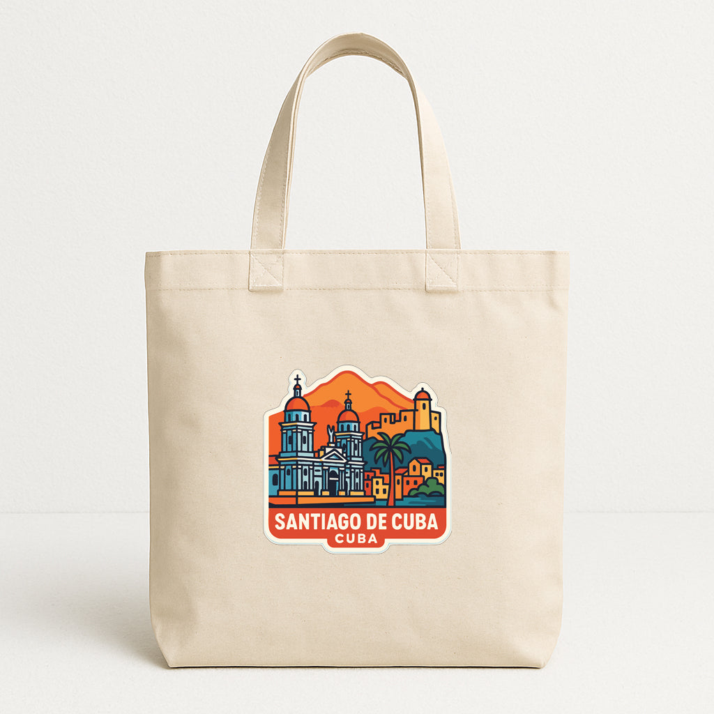 A beige tote bag with a printed design depicting the skyline of Santiago de Cuba.
