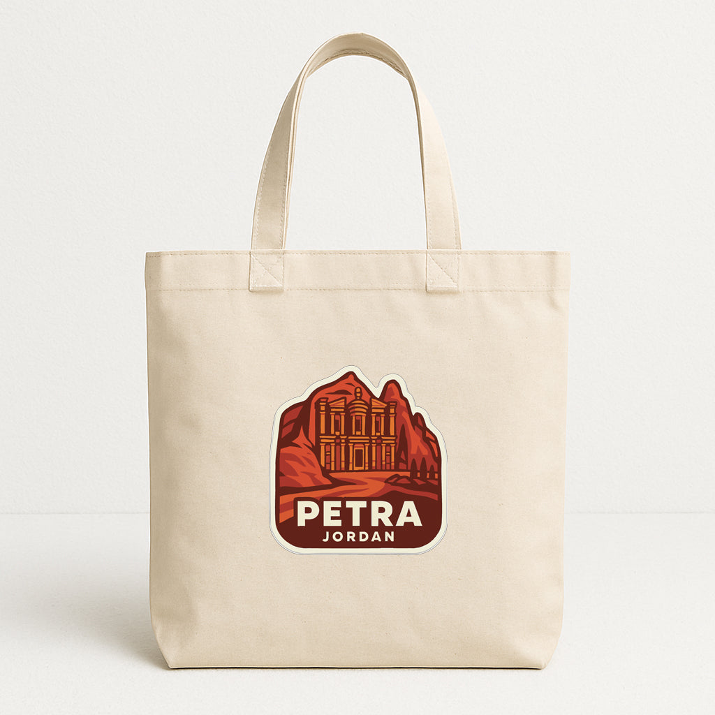 A beige tote bag with a graphic design featuring a castle or palace-like structure and the text "PETRA JORDAN" printed on it.