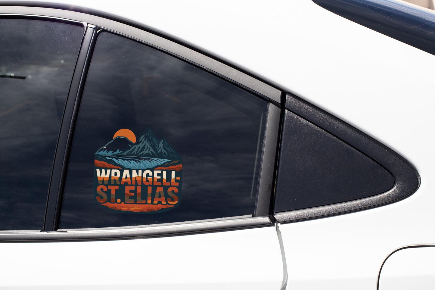 A car window with a sticker on it, featuring a mountain landscape and the text "WRANGEL-ST. ELIAS".