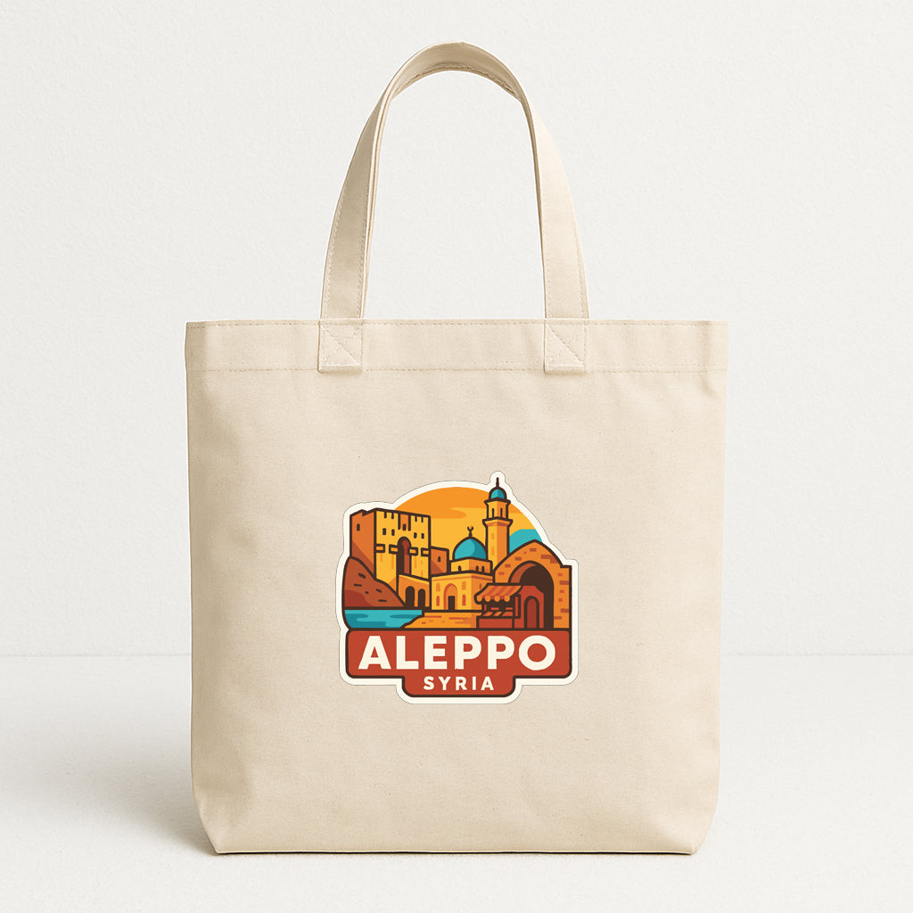 A beige tote bag with a graphic design depicting the city of Aleppo, Syria.