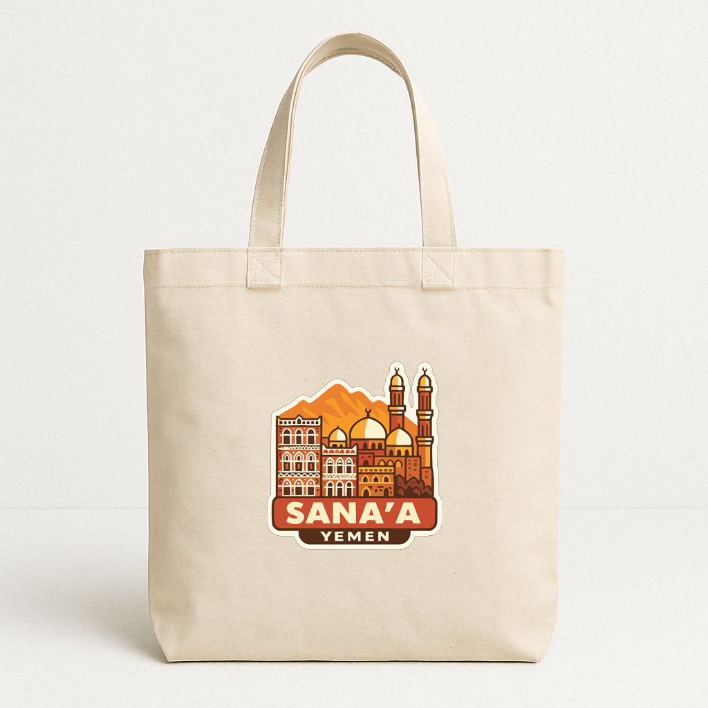 a beige tote bag with a graphic design depicting the skyline of Sana'a, Yemen.