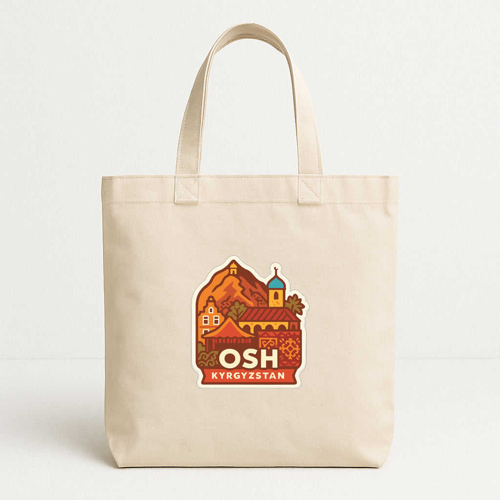 A beige tote bag with a colorful graphic design depicting a village or town, along with the text "OSH Kyrgyzstan" printed on it.