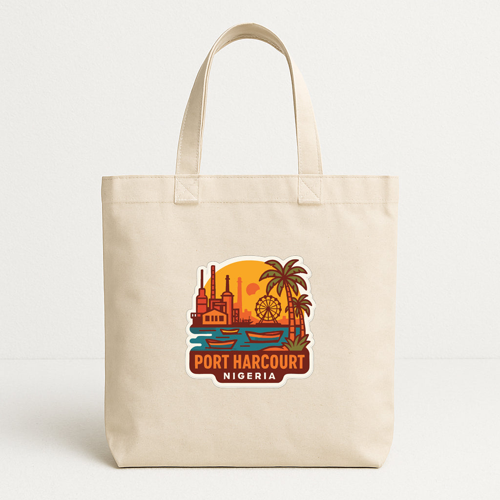 A beige tote bag with a printed design depicting a cityscape and palm trees, along with the text "PORT HARcourt NIGERIA".
