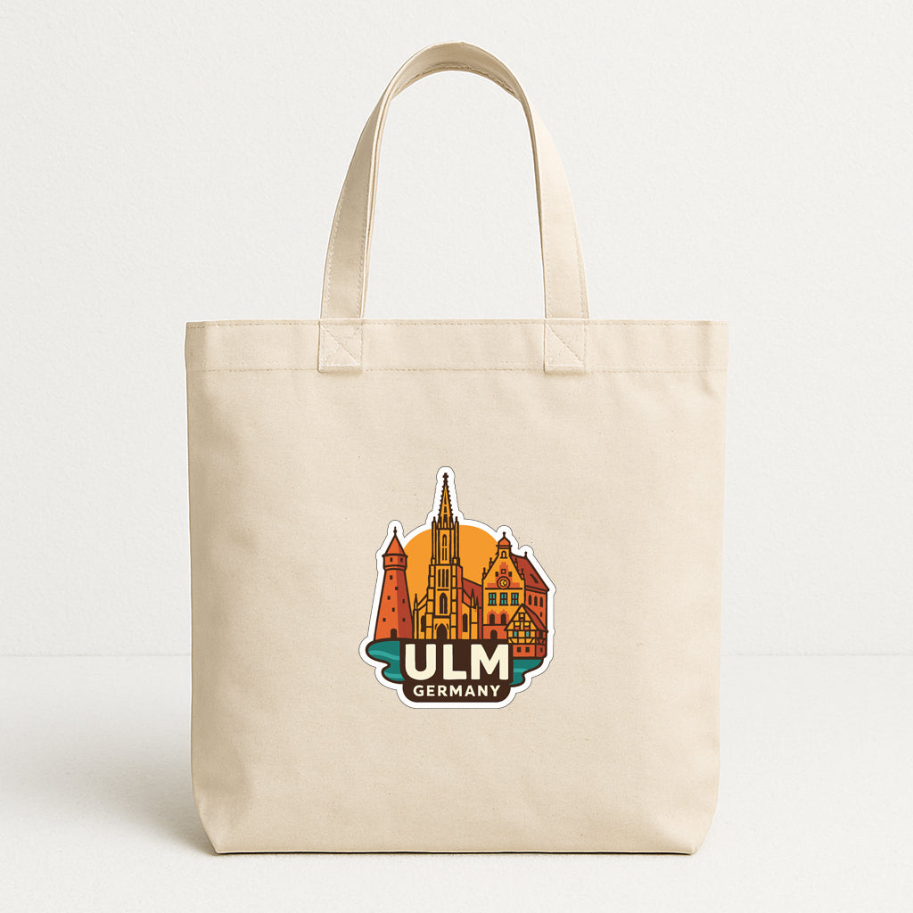 A beige tote bag with a graphic of a city skyline and the text "ULM GERMANY" printed on it.