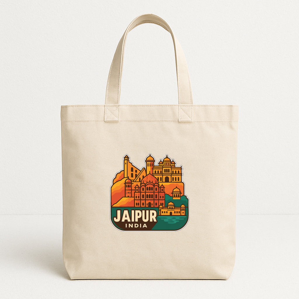 A beige tote bag with a printed design of the city of Jaipur, India, featuring colorful buildings and landmarks.