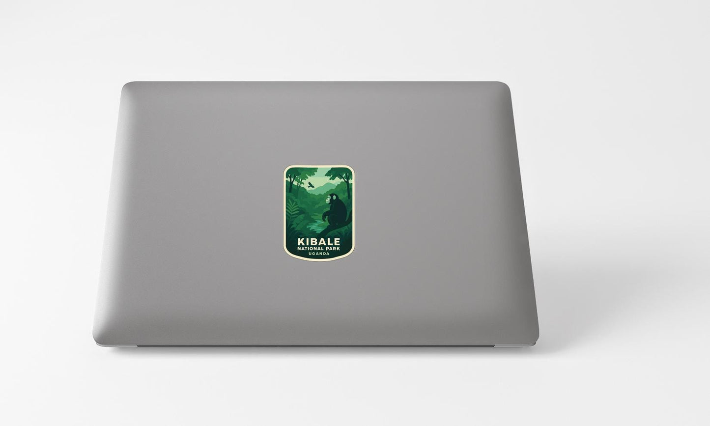 A sticker with a green and white design on a grey laptop.