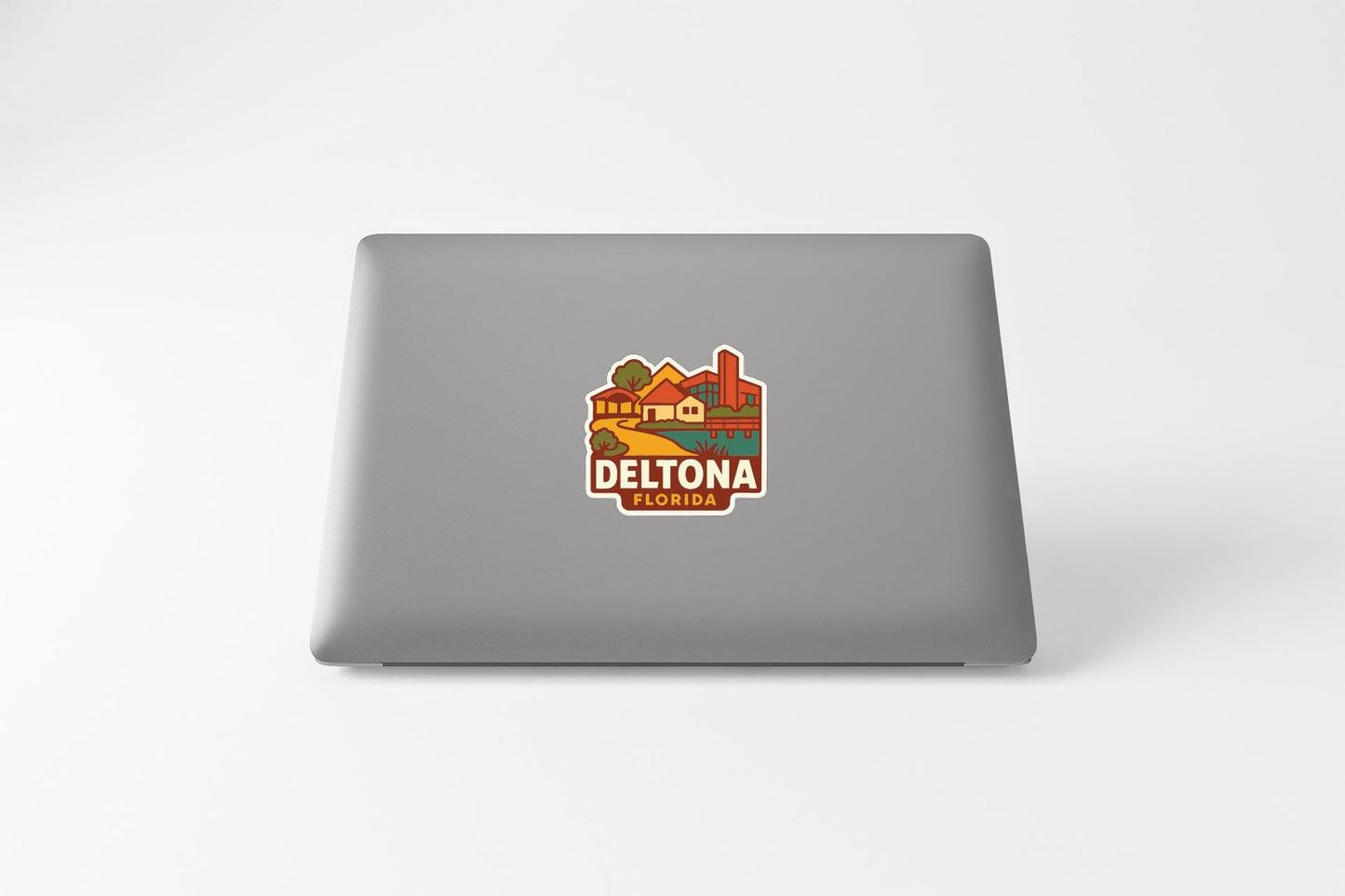 a sticker with a colorful illustration of a town or city, along with the text "DELTONA" prominently displayed.