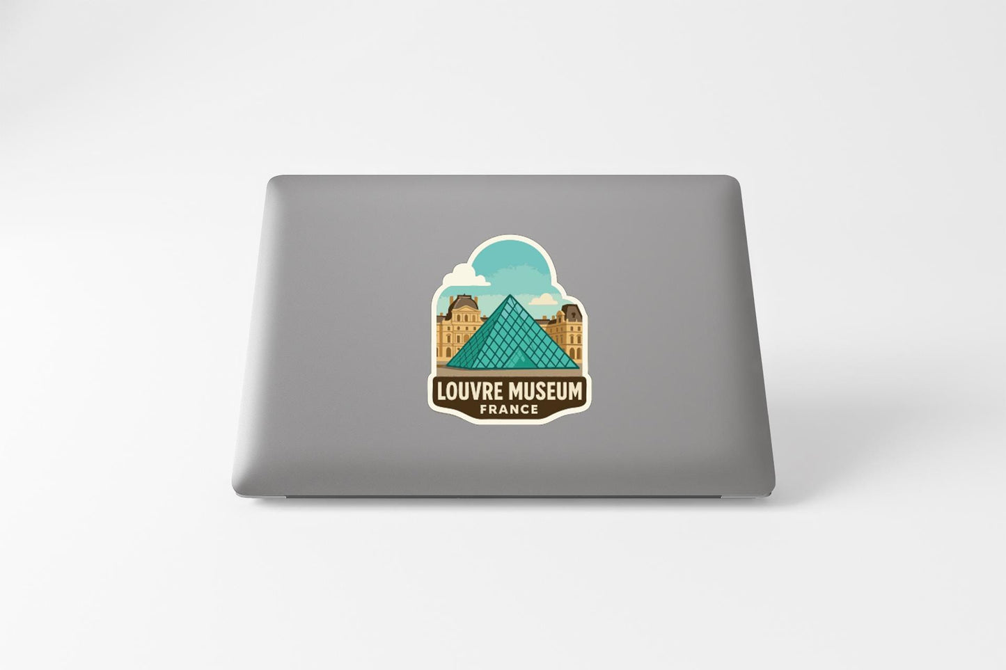 a sticker or decal of the Louvre Museum in France on the back of a laptop computer.