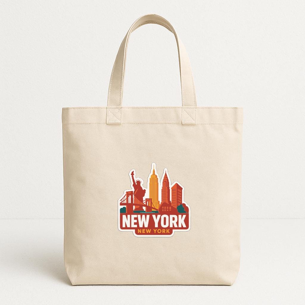 A beige tote bag with a printed design of the New York City skyline and the text "NEW YORK NEW YORK" on it.