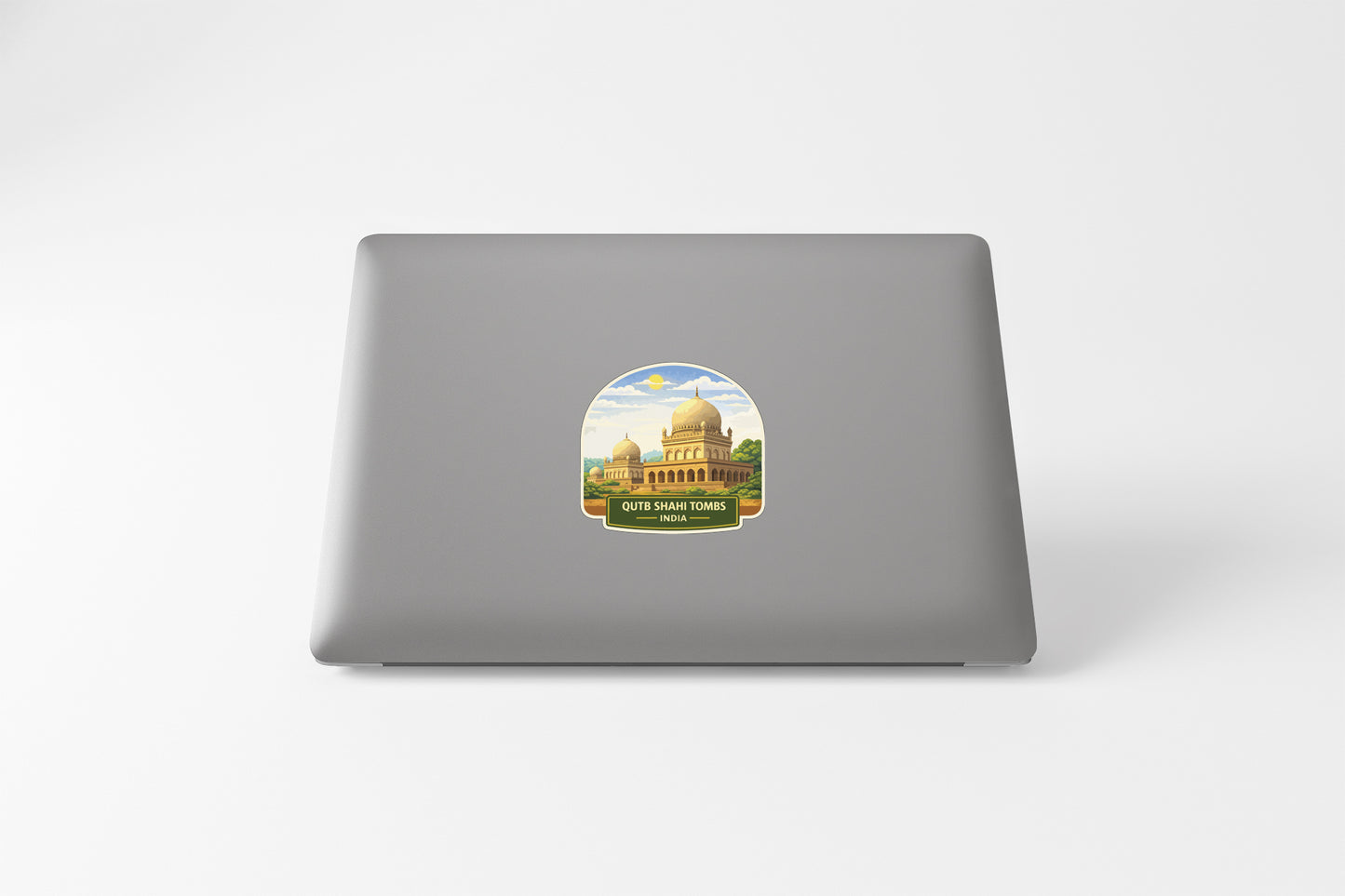 a sticker with a picture of a building, likely a mosque, on the back of a laptop.