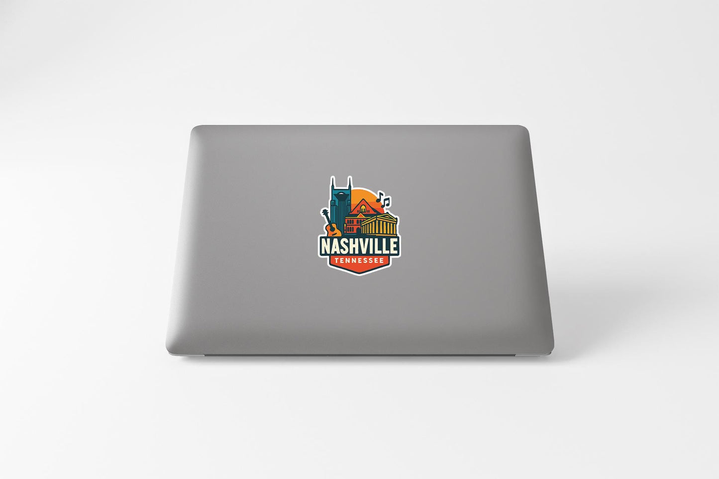 a laptop computer with a sticker of nashville on it