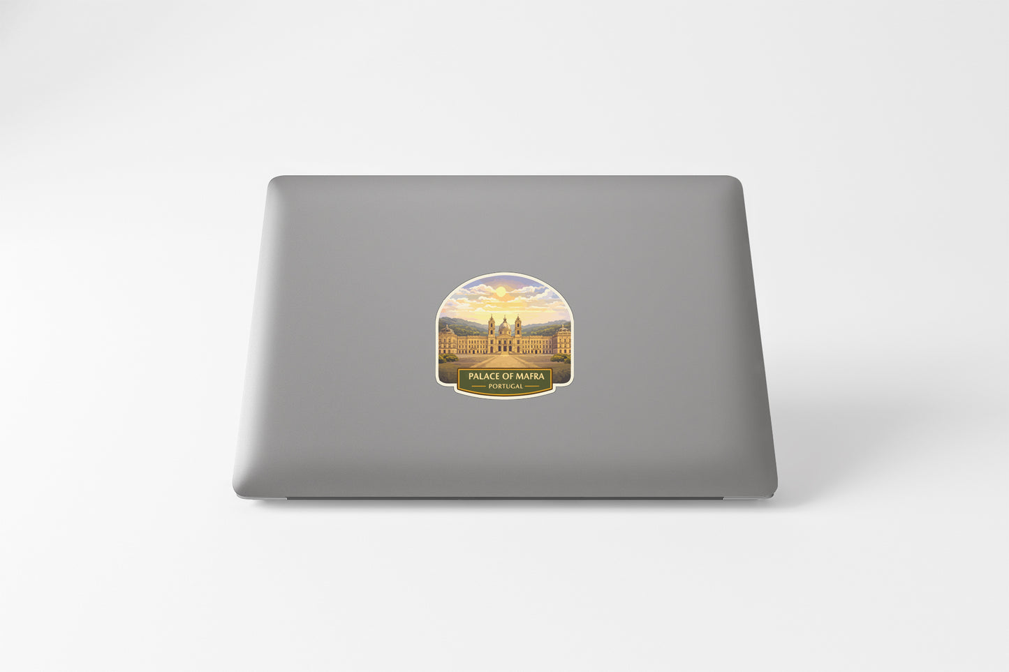 a sticker with a picture of a building and the text "Project of MARA" on a grey laptop.