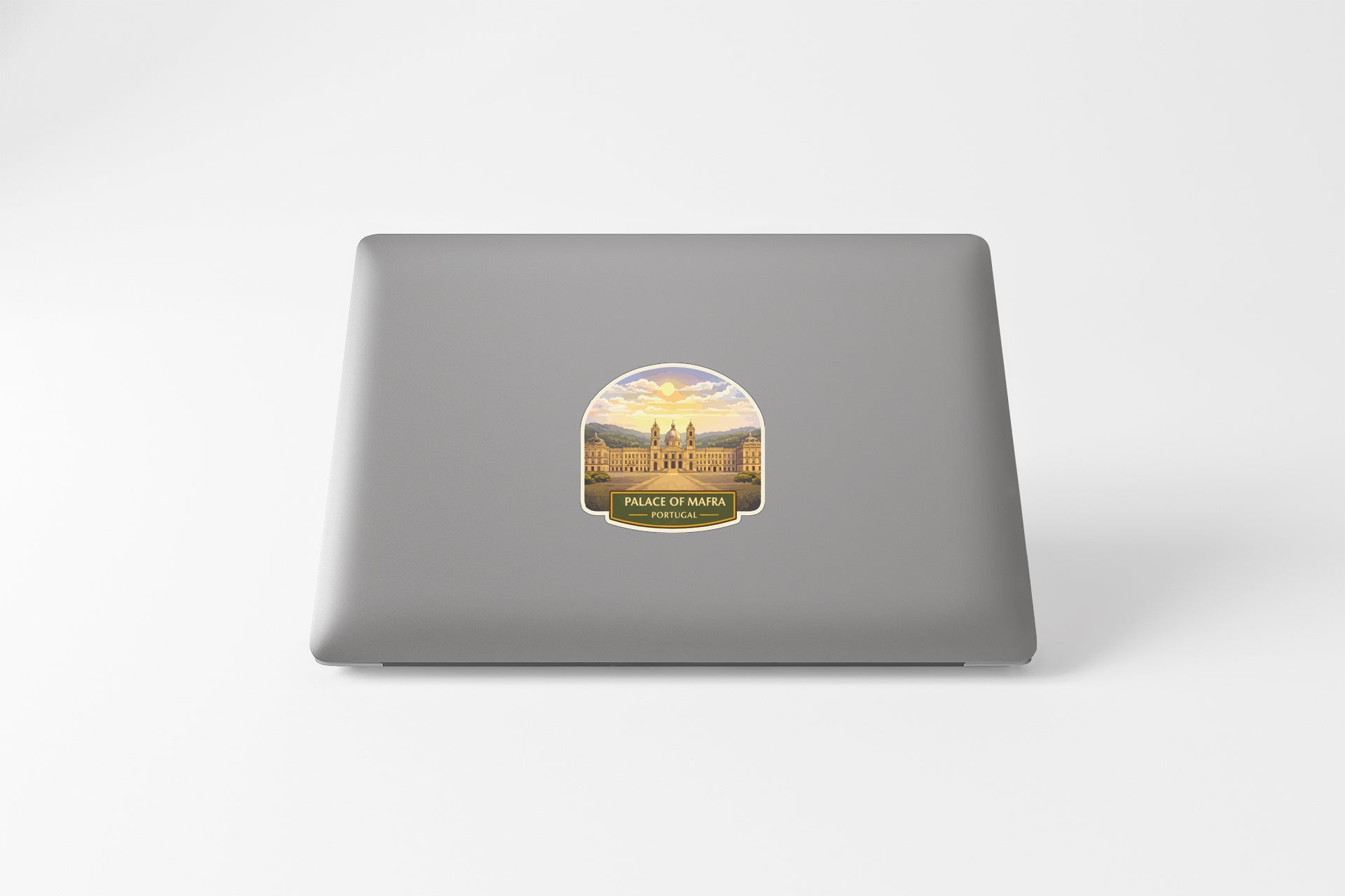 a sticker with a picture of a building and the text "Project of MARA" on a grey laptop.