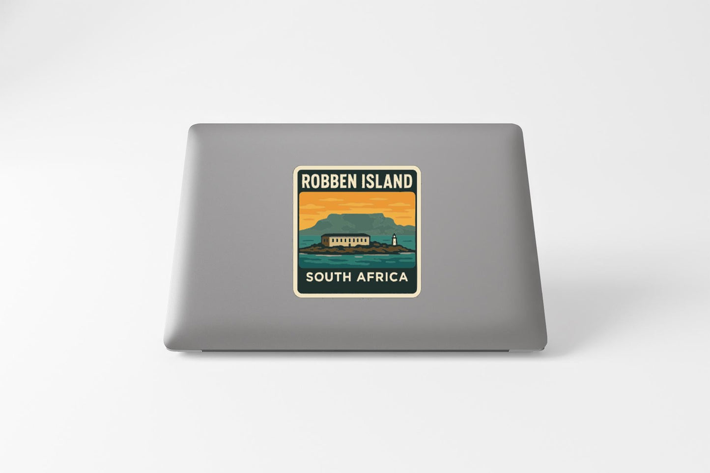 a sticker on a laptop that says "Robben Island South Africa".