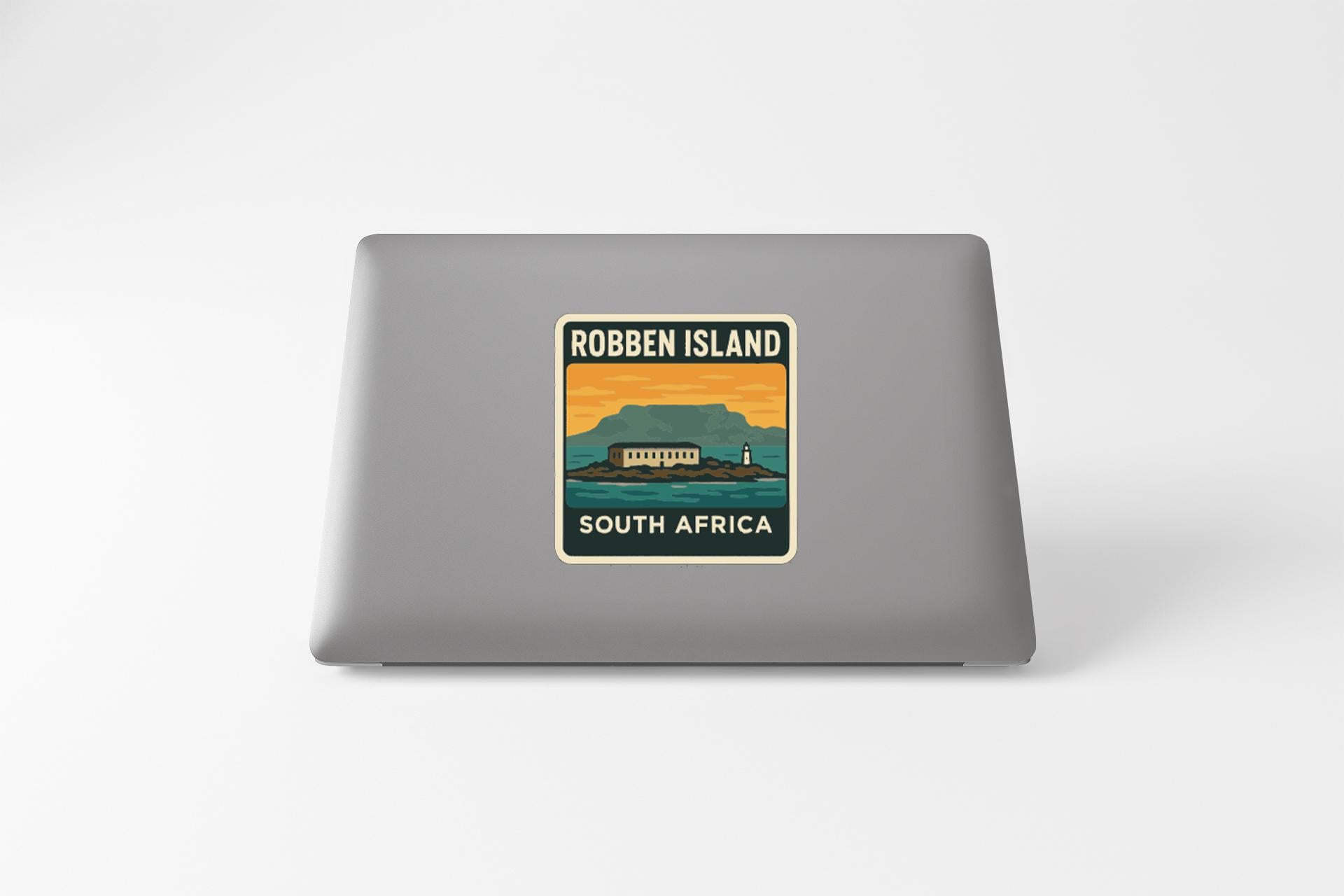 a sticker on a laptop that says "Robben Island South Africa".