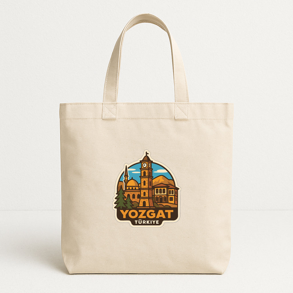 A beige tote bag with a printed design depicting a cityscape and the text "YOZGAT TURKISH".