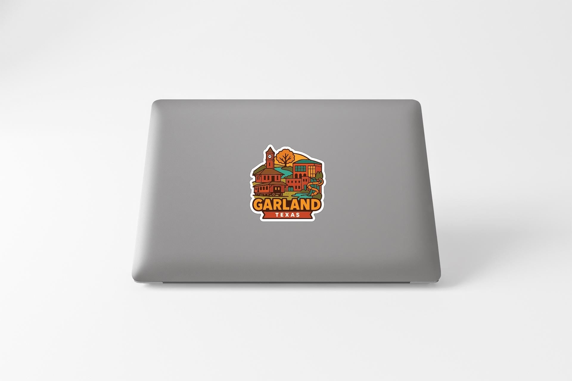 a sticker of the city of Garland, Texas, on the back of a laptop.