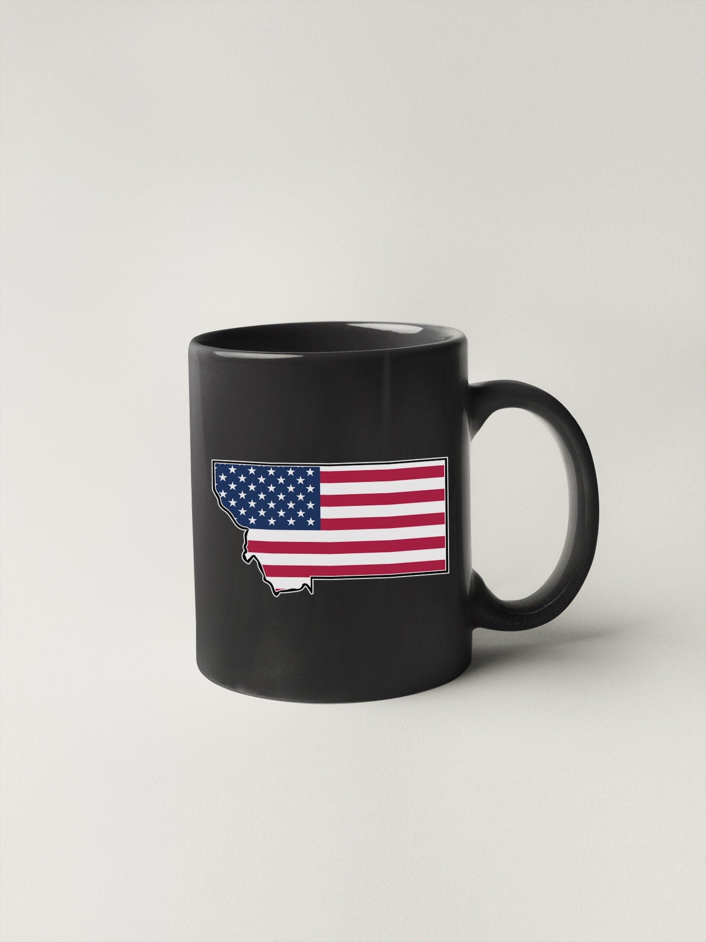 a black coffee mug with the american flag on it