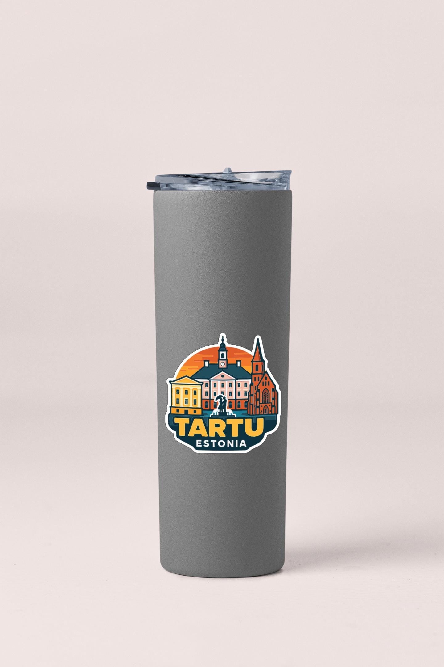 A gray insulated tumbler with a circular sticker featuring the cityscape of Tartu, Estonia.
