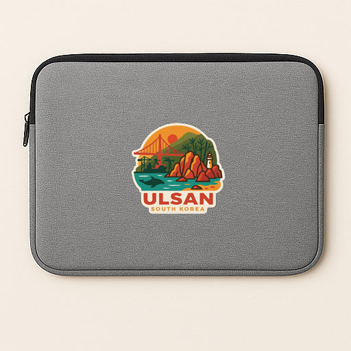 A gray laptop sleeve with a sticker depicting a scenic landscape of Ulsan, South Korea.