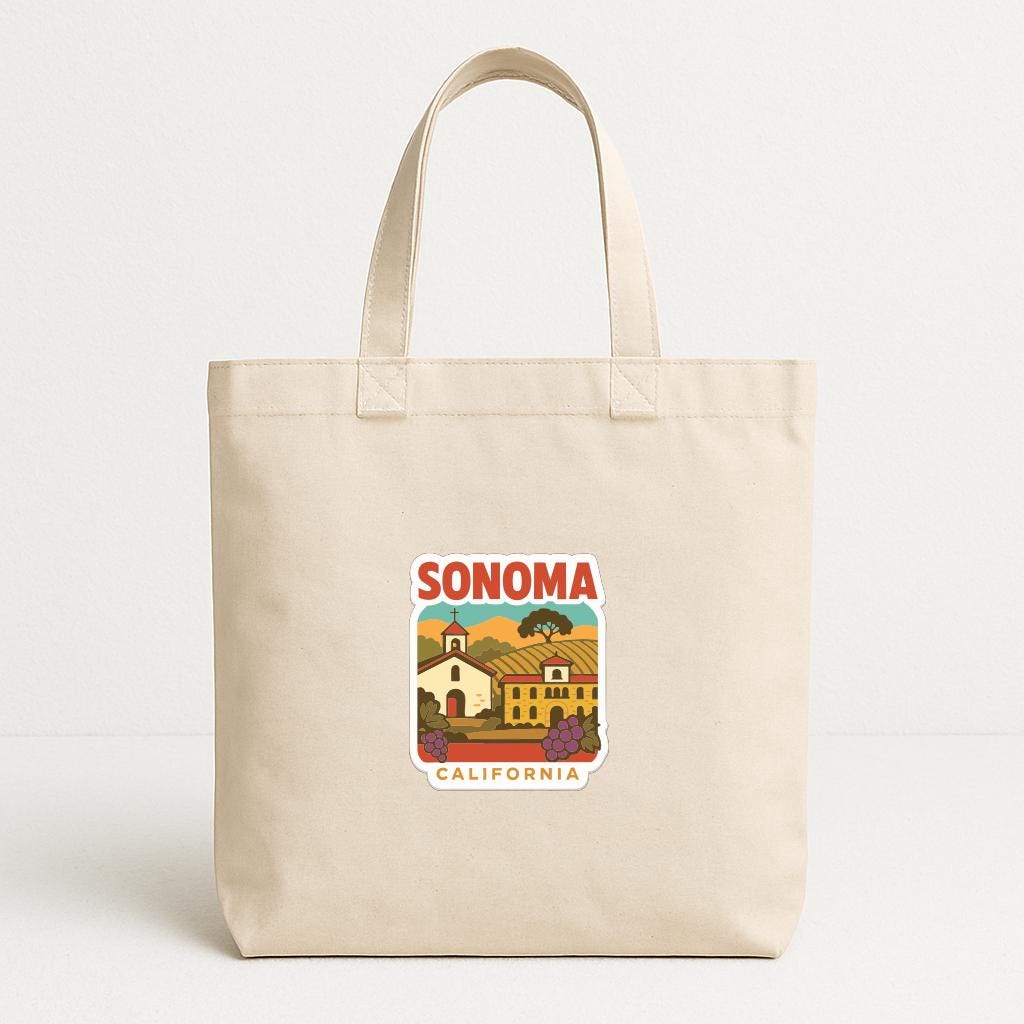 A beige tote bag with a printed design of a town and the text "SONOMA, CALIFORNIA" on it.