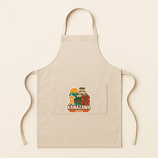 A beige apricot with a graphic design featuring a castle and the text "KANAZAWA JAPAN" printed on it.