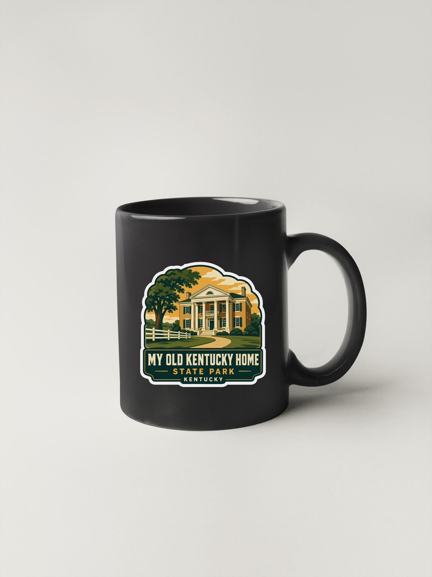 A black coffee mug with a graphic design depicting a house and trees, along with text that reads "My Old Kentucky Home State Park Kentucky".