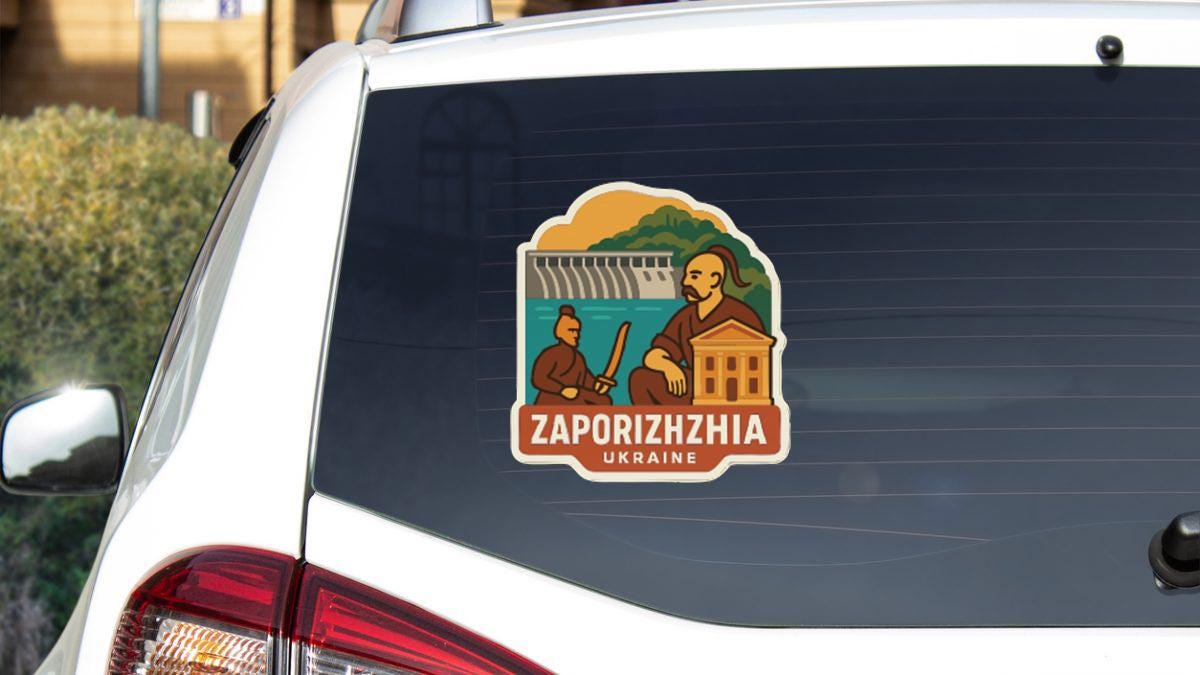 A sticker on the rear window of a car, depicting a man in a robe and holding a book, with the text "ZAPORIZHZIA UKRAINE" below.