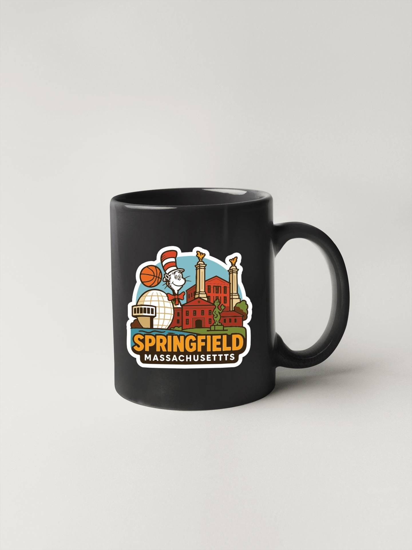 A black coffee mug with a colorful graphic depicting the city of Springfield, Massachusetts.