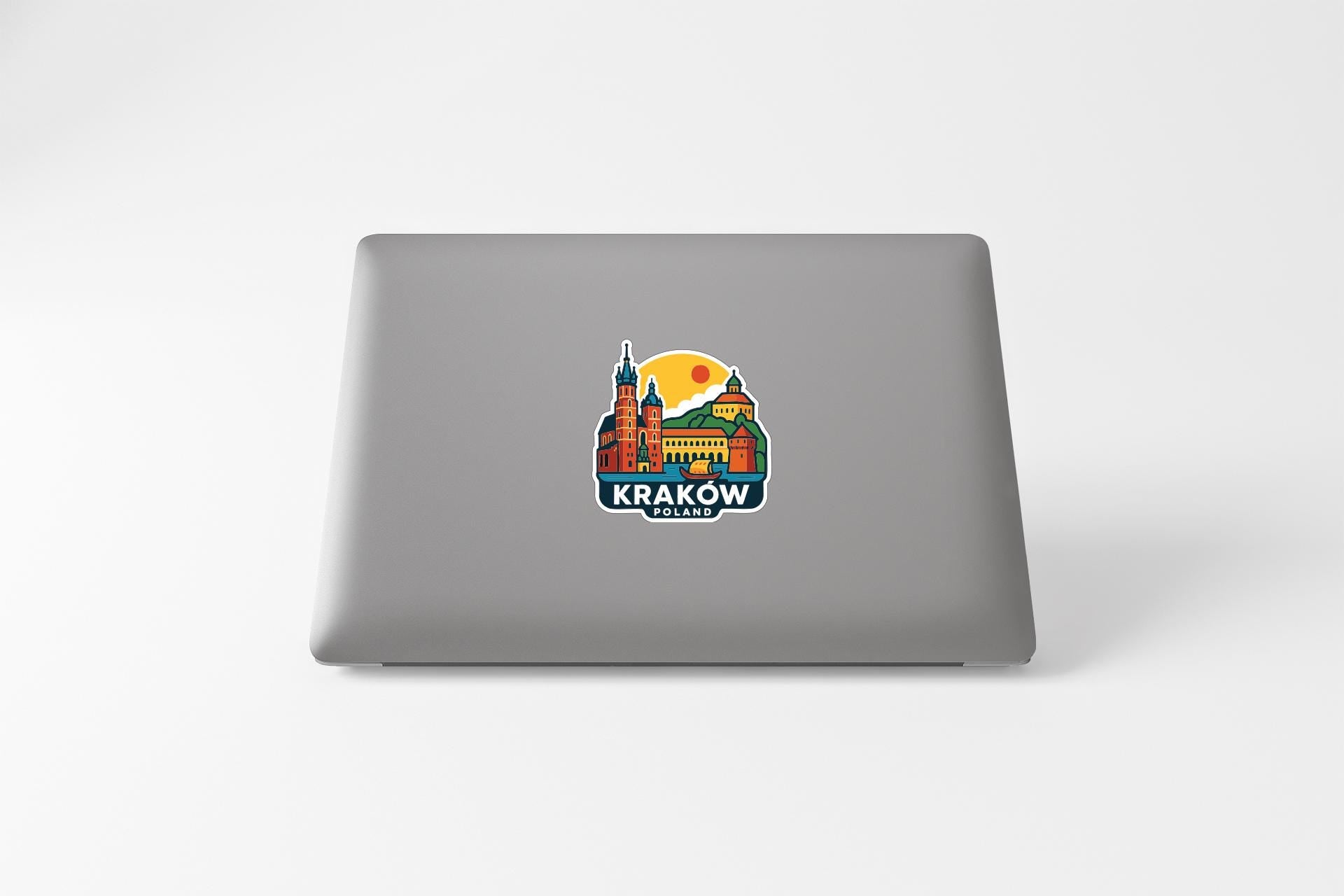 A sticker featuring a colorful illustration of a building and a sun, with the text "Krakow" prominently displayed.